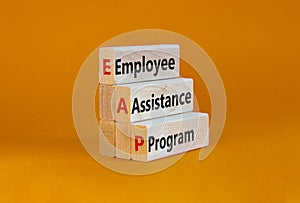 EAP employee assistance program symbol. Concept words EAP employee assistance program on blocks on a orange table, orange