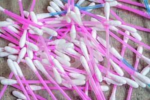 Ear buds or Cotton swabs used for cleaning ears kept on a textured grey table