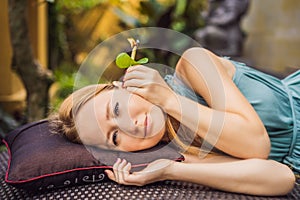 Ear candling being carried out on an attractive caucasian woman in a spa