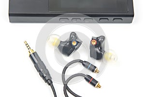 In-ear headphones for Hi-Fi music player. Audio sound and modern equipment for music lovers and audiophiles photo