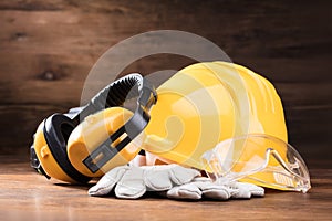 Ear Muff, Safety Glasses, And White Gloves On Table