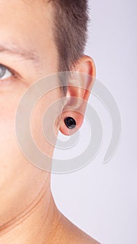 Ear pierced guy,man wears a piercing