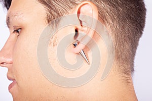 Ear pierced guy,piercing stretching to increase the diameter of the tunnels