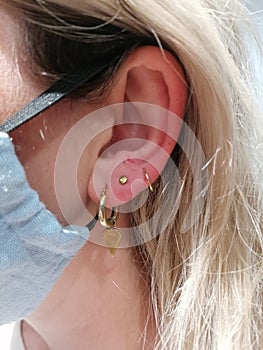 Ear piercing with Yellow Gold Disk