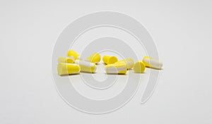 Ear plugs for protection against noise in yellow and white.