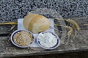 Ear of wheat, grain and flour over old table