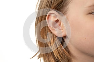 ear of a young child close-up on a white background