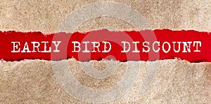 Early bird discount appearing behind torn paper.Business