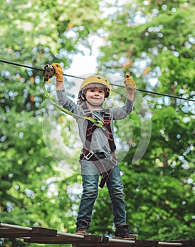 Early childhood development. Eco Resort Activities. Playground. Kids boy adventure and travel. Little child climbing in