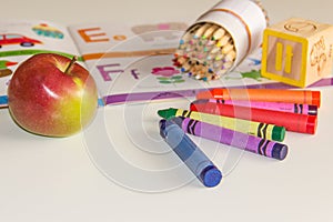 Early childhood learning with book and crayons. photo