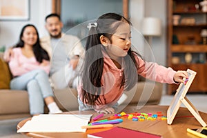 Asian Little Daughter Playing With Alphabet Board Learning At Home