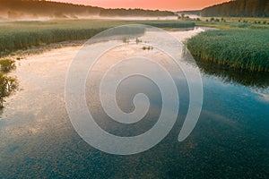 Early misty morning, sunrise over the lake