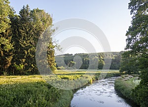 early moring landscape of fast flowing river ourthe in belgian ardennes region photo