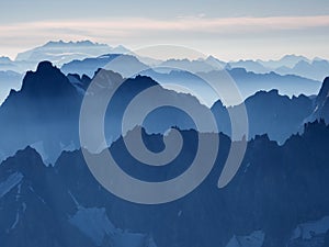 Early morning Alpine landscape with rows of steep peaks