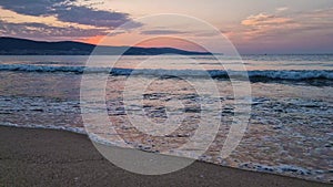 Early morning on the beach with a peaceful view to the sunrise above the sea. Calm seascape dawn scene, natural background