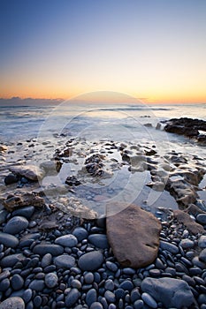 Early morning landscape of ocean over rocky shore
