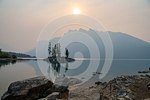 Early morning light showing tranquil scene of Island in Lake Minnewanka