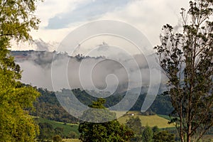 Early in the morning low clouds cover with mist the central Andean mountains