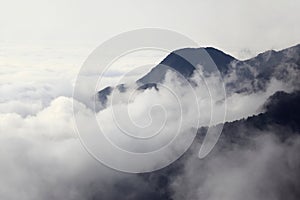 Early morning mist flowing over high mountains and valleys