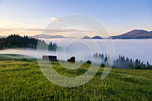 The early morning mist. Majestic spring day. A beautiful landscape with high mountains, sunset and sky with clouds. Dense fog with