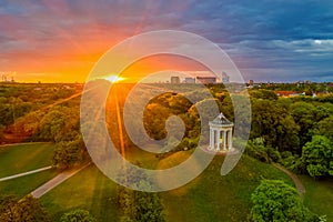 Early in the morning, the Monopteros temple in the English Garden in Munich, Germany with sun rays