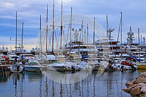 Early morning in port of Monaco. Rows of luxury yachts and different boats moored at the pier. Landscape view of port in Monaco