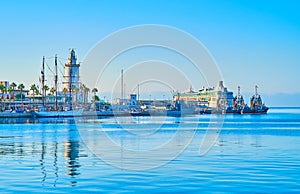 La Farola lighthouse, yachts and ships in Malaga port, Spain photo