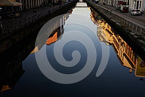 Early morning reflection in canal in Milan city center