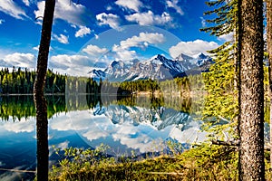 Early morning reflections in the crystal clear waters of Herbert Lake. Banff National Park Alberta Canada