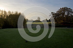 Early morning shadows and dew cover the lawns of Cedar Hill Golf Course as seen from a tee off