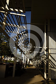 Early morning sun shining through louvres and making shadows.