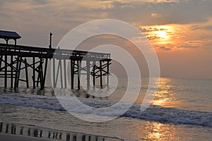 The early morning sunblurs as it goes behind the morning cloudbank on the ocean horizon