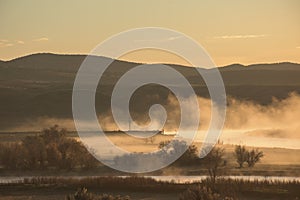 Early Morning Sunrise Along Misty River Landscape