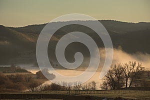 Early Morning Sunrise Along Misty River Landscape