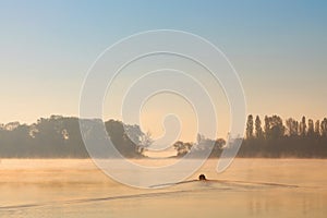 Early morning sunrise, boating on the lake in a huge fog