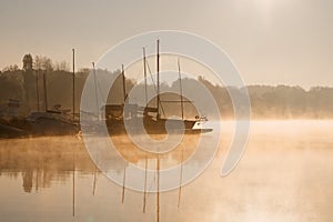 Early morning sunrise, boating on the lake in a huge fog