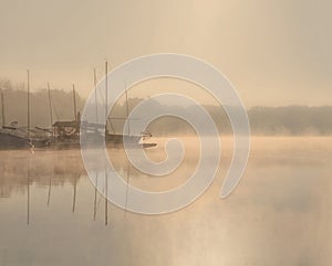 Early morning sunrise, boating on the lake in a huge fog