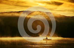 Early morning sunrise, boating on the lake in the sunlight photo