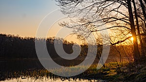 Early morning sunrise. Lake in the sunlight. Gdansk Stogi, Empty pond.