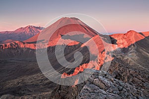 Early morning sunrise, landscape scenery of blue lake, wild mountains and huge volcano, autumn colours and golden sun rays.