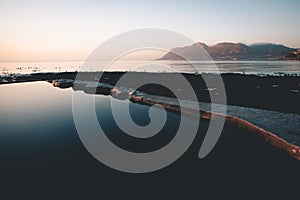 Early morning sunrise over a tidal pool by the sea