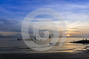 Early morning sunset with Vew of volcano Agung mountains of Bali and sea and beach, Bali, Indonesia. Azure beach, rocky