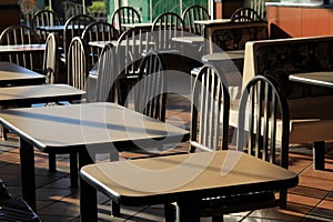 Early morning sunshine on tables and booths of restaurant
