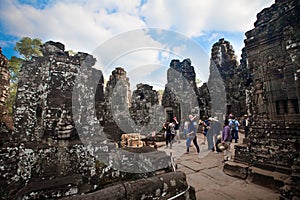 Early morning tourist visiting the Bayon temple, part of Angkor Thom ruin ancient temple Cambodia