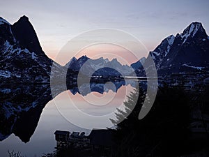 Early morning or twilight evening at Reine fishing village, Lofoten Islands, Norway, landscape and seascape, water reflection of