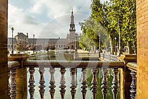 An early morning view along a canal in the Plaza de Espana in Seville, Spain