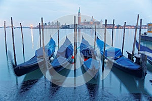 Early morning view of romantic Venice in blue twilight, with gondolas on the Grand Canal and San Giorgio Maggiore Church on an isl