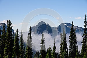 Early morning view of the Tatoosh Mountain Range with craggy peaks and mist rising from below