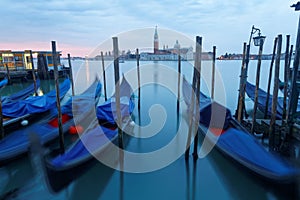 Early morning view of Venice with San Giorgio Maggiore Church in the background and gondolas parking in the Grand Canal