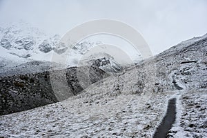 Early snow covers the mountain trail to Lake Donguzorun Kol